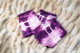 Three pairs of tie dye bamboo boyshorts folded together, the 3-pack